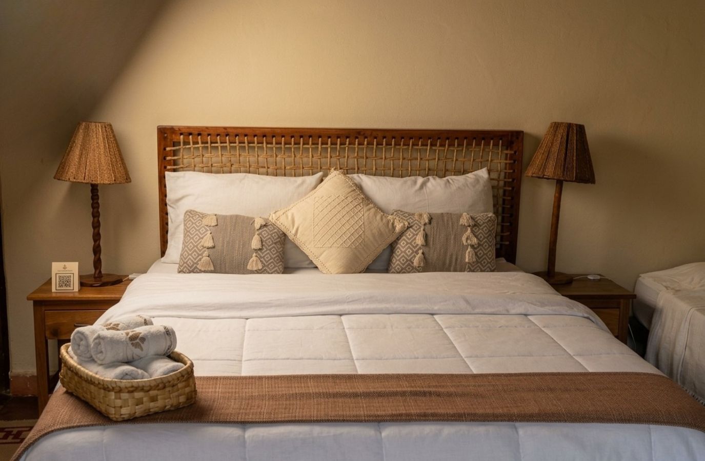 Double room with woven headboard and cushions