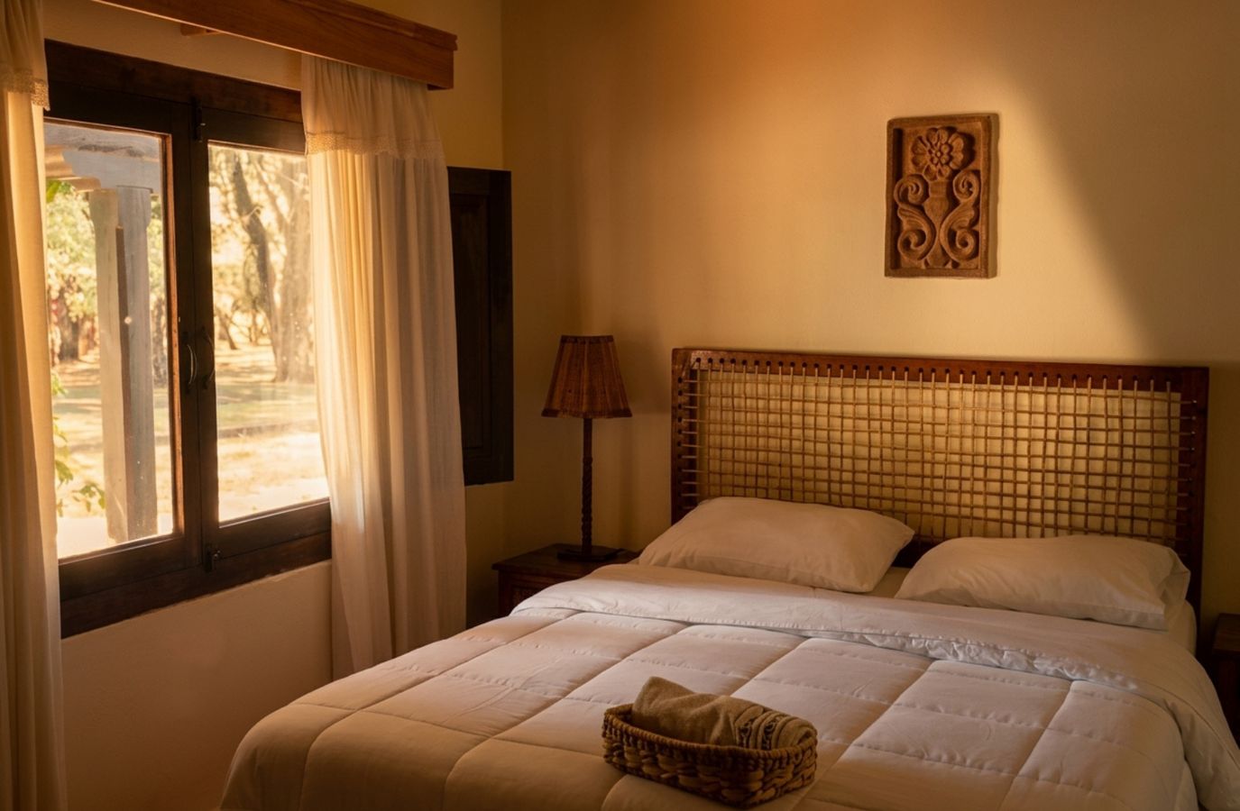 Room with window and stone-carved wall piece