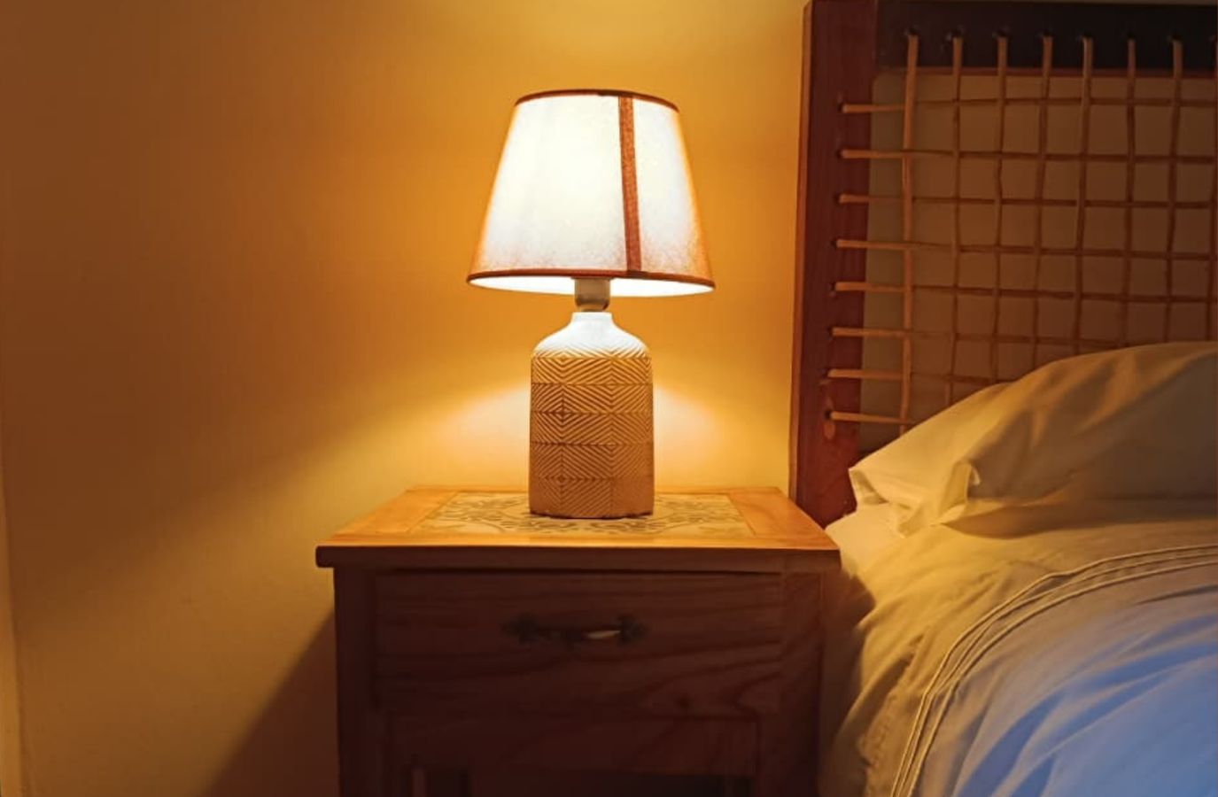 Wicker lamp by the bed