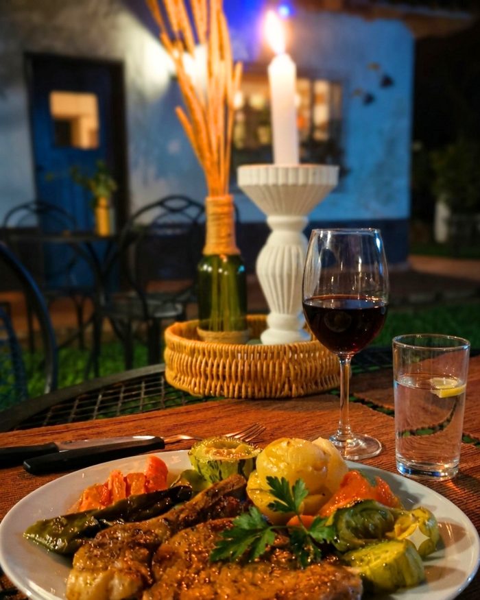 Dinner detail with a glass of wine by candlelight