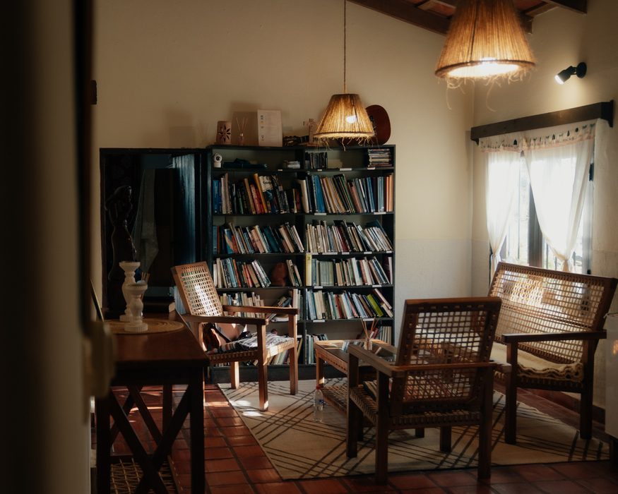 Reading room with wicker armchairs and bookshelves
